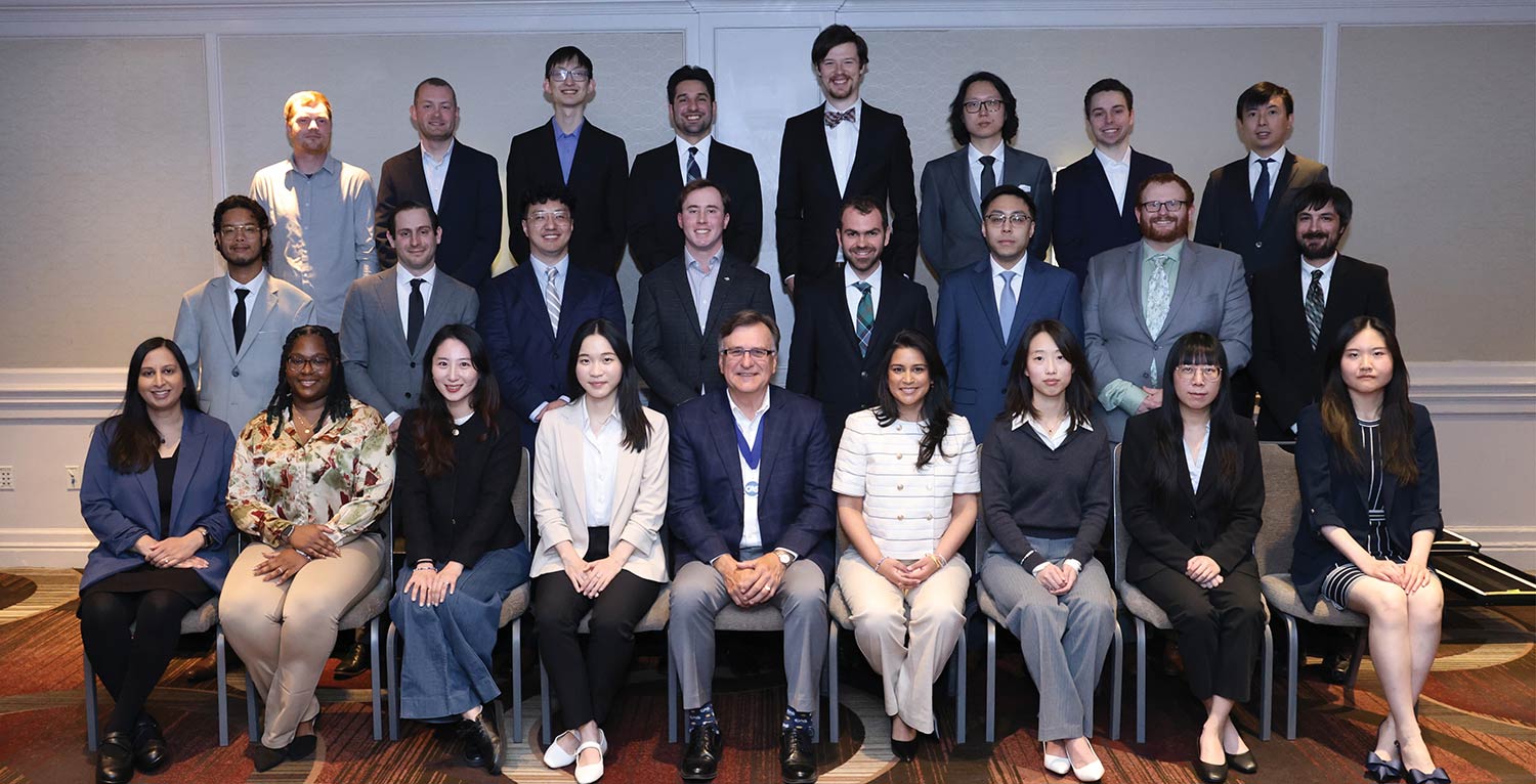 Group photo of newly credentialed CAS associates standing and sitting in rows.