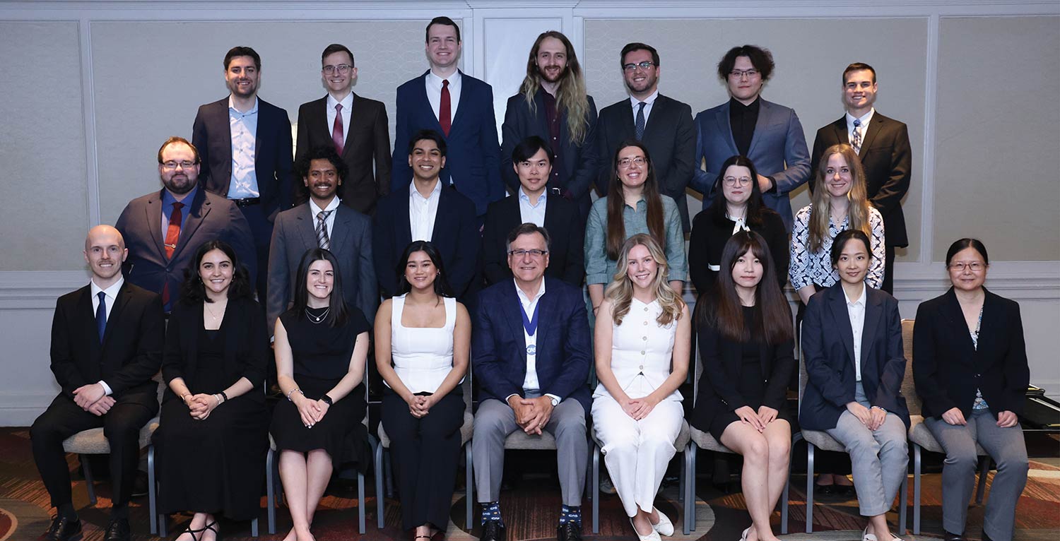 Group portrait of new CAS associates posing with the CAS President.