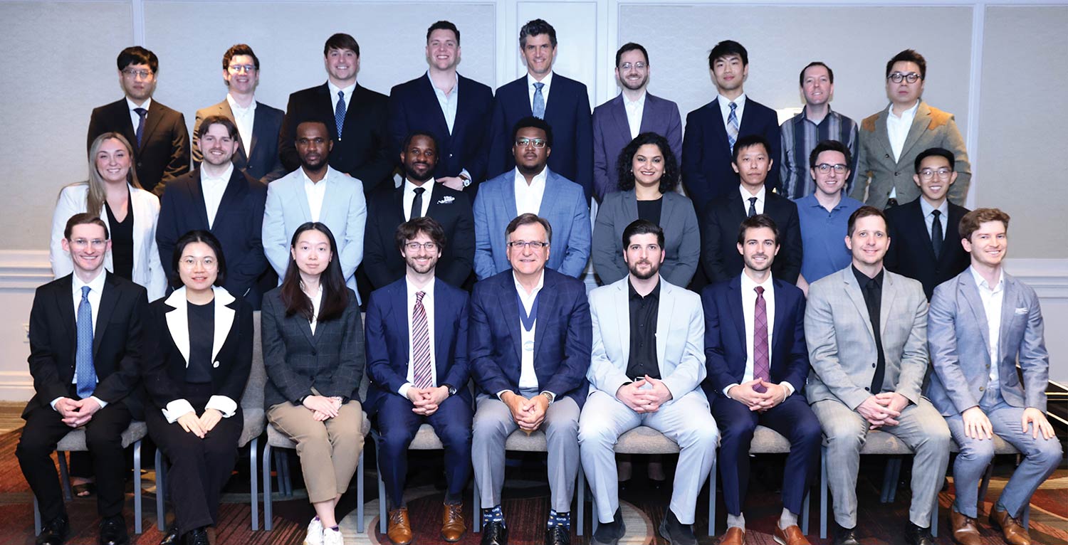 Group portrait of newly recognized CAS associates standing and sitting together.